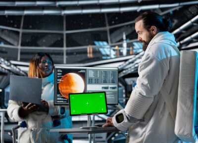 Space station researchers analyzing Mars planetary data using isolated screen tablet. Team of scientists in futuristic spaceship doing Martian surface research using mockup device